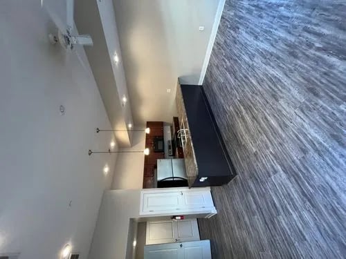 Modern kitchen with dark counter, stainless steel appliances, cabinets Kitchen at 9 North Apartments in Bloomington Student Accommodation