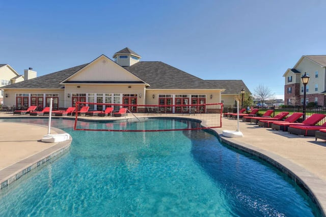 Pool volleyball court lounge chairs exterior at The Grove Apartments Stephenville in Stephenville Student Accommodation