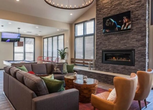 Sofa fireplace TV pool table and chairs living room at The Lodge at Allendale in Allendale Student Accommodation