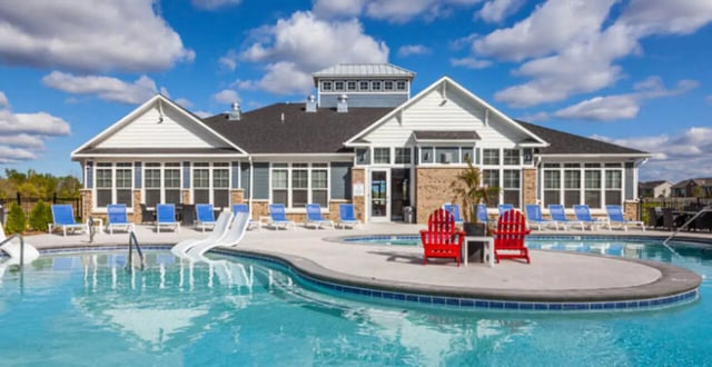 Poolside lounge chairs and building exterior exterior at The Lodge at Allendale in Allendale Student Accommodation