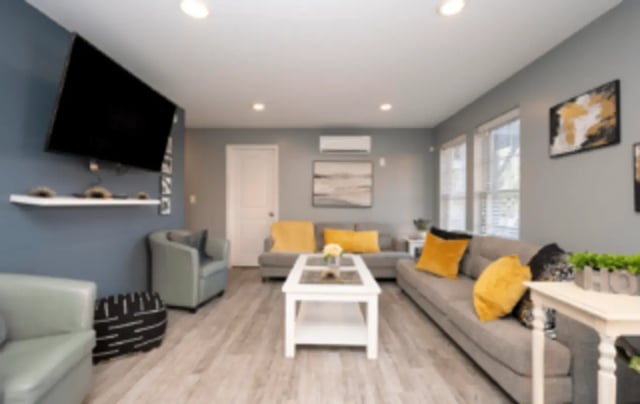 Sofas coffee table chairs and TV living room at Victory Villages in Winston-Salem Student Accommodation