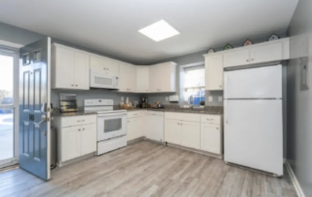 White cabinets stove refrigerator kitchen at Victory Villages in Winston-Salem Student Accommodation
