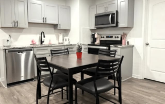 Dining table chairs microwave dishwasher kitchen at Victory Villages in Winston-Salem Student Accommodation