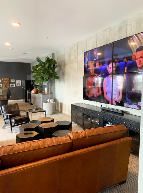 Sofa, chairs, and TV wall lounge area at Eight Thirty Water Tower Apartments in Big Rapids Student Accommodation