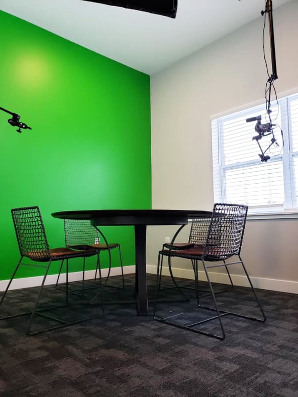 Round table with chairs and camera setup study area at Eight Thirty Water Tower Apartments in Big Rapids Student Accommodation