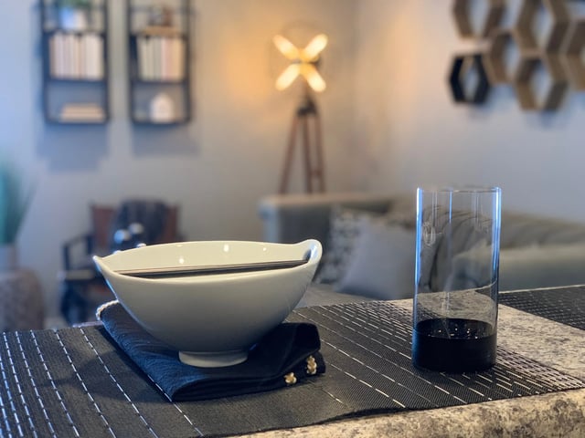 Bowl chopsticks glass on table living area at Eight Thirty Water Tower Apartments in Big Rapids Student Accommodation