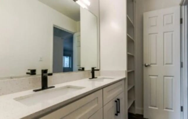 Double sinks vanity white cabinets and shelves bathroom at Victory at Burcham Woods (731) in East Lansing Student Accommodation