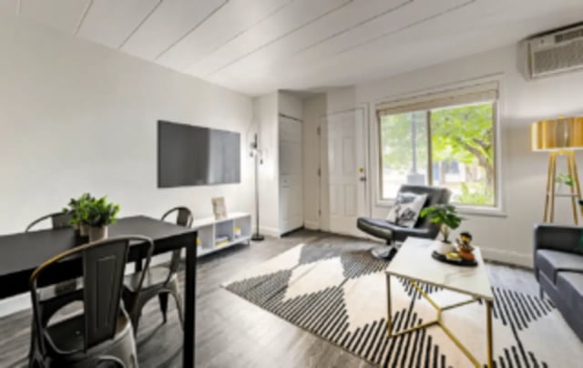 Black table chairs TV rug chair living room at Victory at Burcham Woods (731) in East Lansing Student Accommodation