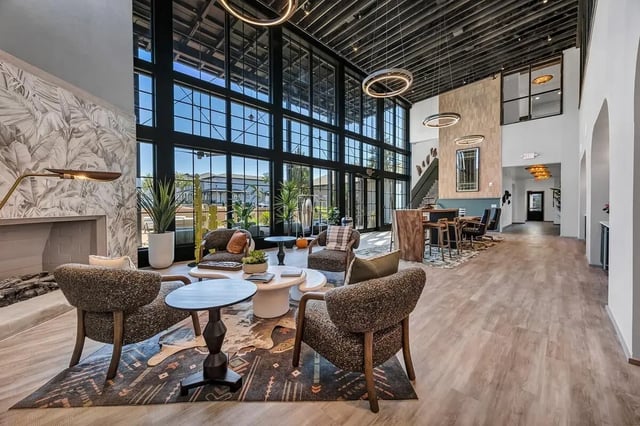 Seating area with fireplace large windows living room at Cottages at San Marcos in San Marcos Student Accommodation