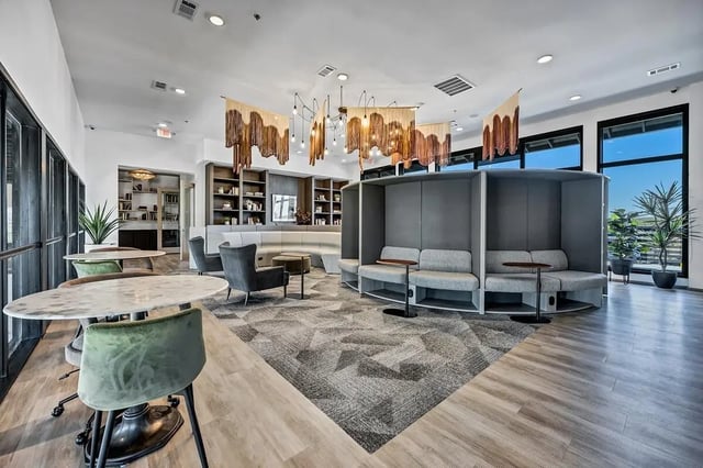 Modern lounge with study pods and marble tables common area at Cottages at San Marcos in San Marcos Student Accommodation