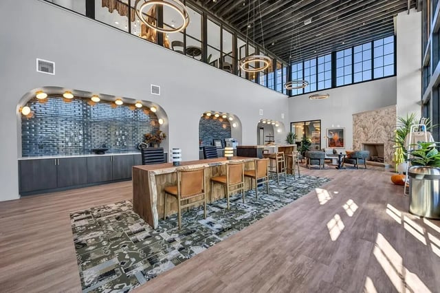 Large communal space with bar tables fireplace lounge area at Cottages at San Marcos in San Marcos Student Accommodation