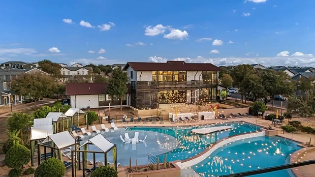 Pool with lounge chairs and cabanas exterior at Cottages at San Marcos in San Marcos Student Accommodation