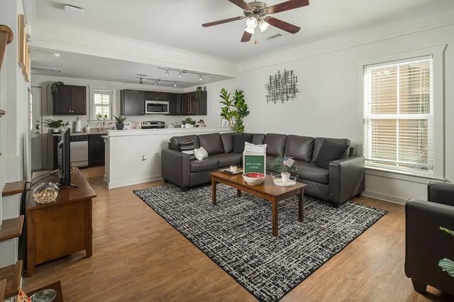 Brown sectional sofa coffee table kitchen living room at Cottages at San Marcos in San Marcos Student Accommodation