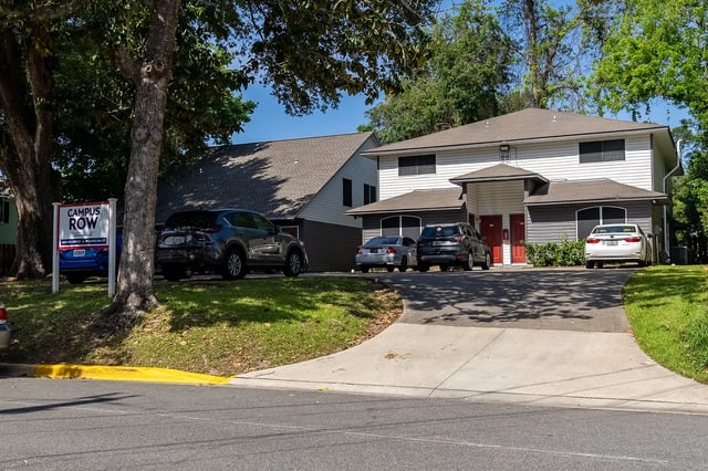 Apartment building with cars and sign exterior at Campus Row in Tallahassee Student Accommodation