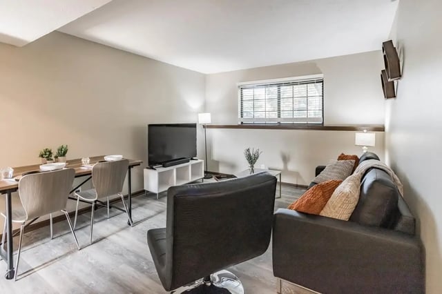 Dining table chairs TV and couch living room at Victory on Salisbury in West Lafayette Student Accommodation