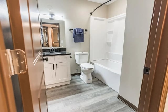 Toilet vanity bathtub and towels bathroom at Victory on Salisbury in West Lafayette Student Accommodation