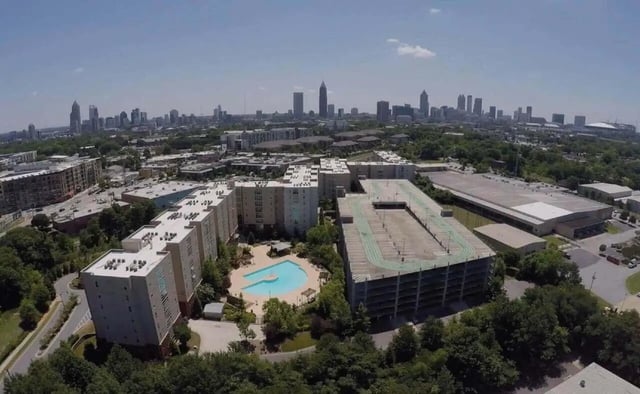 Apartment buildings surrounding pool and parking garage exterior at Westmar Student Lofts in Atlanta Student Accommodation