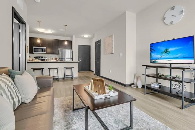 Sofa kitchen TV and coffee table living room at 930 NoMo in Charleston Student Accommodation