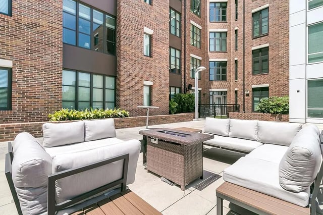 Outdoor seating area with sofas and fire pit exterior at 930 NoMo in Charleston Student Accommodation