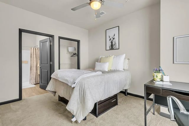 Bed closet and shower visible bedroom at 930 NoMo in Charleston Student Accommodation