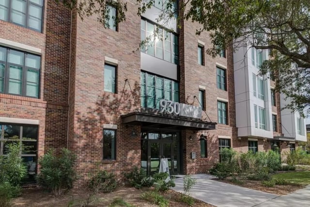 Brick building with entrance and address 930 Exterior at 930 NoMo in Charleston Student Accommodation