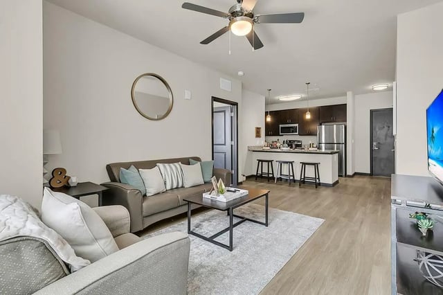 Sofa bar stools and kitchen area living room at 930 NoMo in Charleston Student Accommodation