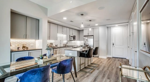 Blue chairs glass table modern kitchen island kitchen at 940 North in Spokane Student Accommodation