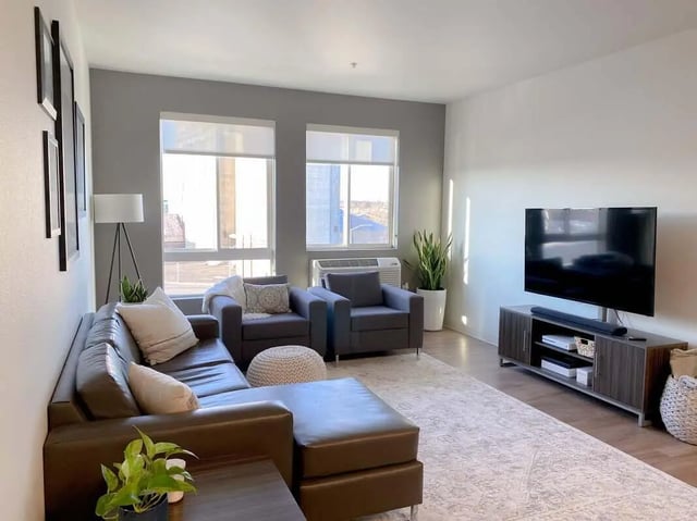 Leather sectional sofa two armchairs ottoman living room at 940 North in Spokane Student Accommodation