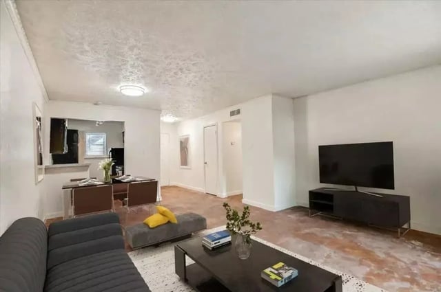 Sofa dining table and TV living room at Denton Student Apartments in Denton Student Accommodation