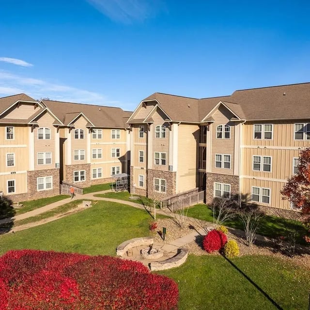 Apartment buildings with fire pit and lawn Exterior at Boone Student Living in Boone Student Accommodation