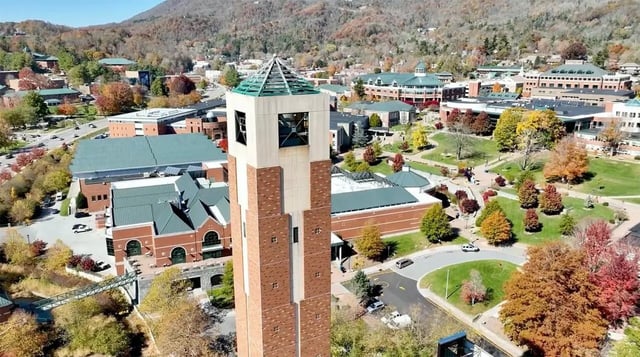 Campus bell tower with brick buildings and autumn trees exterior at Boone Student Living in Boone Student Accommodation