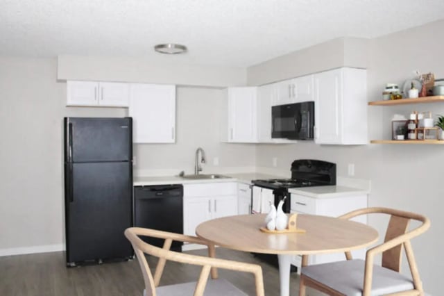 Black refrigerator white cabinets dining table kitchen at Cougar Ridge Apartments in Pullman Student Accommodation