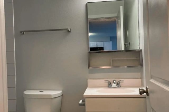 Toilet sink and mirror bathroom at Cougar Ridge Apartments in Pullman Student Accommodation