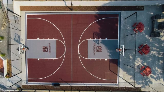 Basketball court with red seating area playing area at Cougar Ridge Apartments in Pullman Student Accommodation