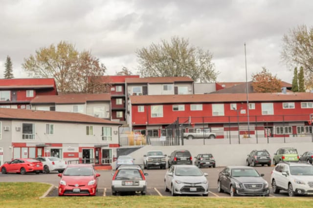 Apartment building parking lot with cars exterior at Cougar Ridge Apartments in Pullman Student Accommodation