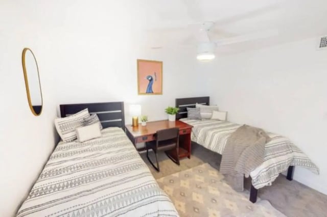 Two beds desk with lamp and artwork bedroom at Glenwood Apartments in Provo Student Accommodation