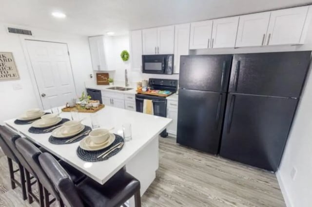 Dining island with place settings and black chairs kitchen Image at Glenwood Apartments in Provo Student Accommodation