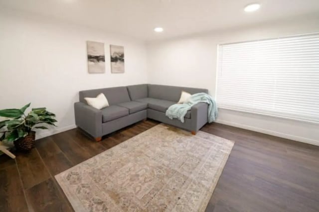 Grey sectional sofa with throws and plant living room at Glenwood Apartments in Provo Student Accommodation