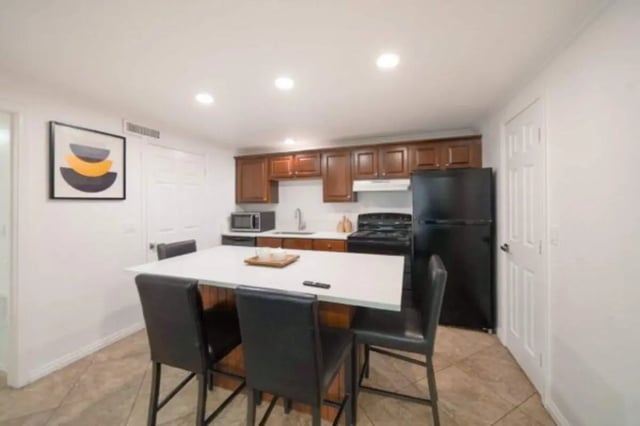 Island with chairs kitchen cabinets appliances painting kitchen at Glenwood Apartments in Provo Student Accommodation