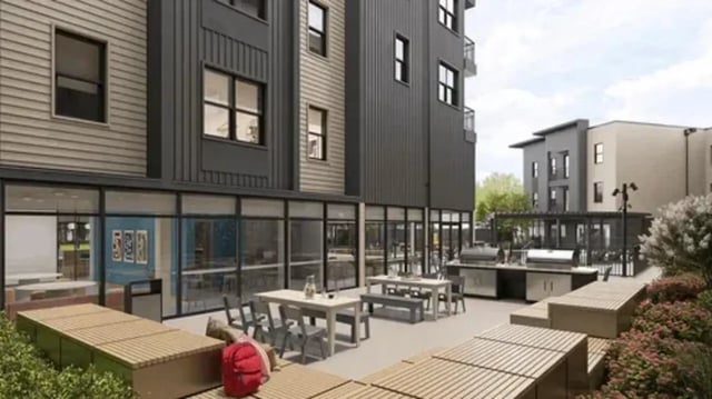 Outdoor seating with tables grills and benches exterior at Global College Station in College Station Student Accommodation