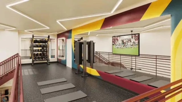 Weights mats and television gym area at Global College Station in College Station Student Accommodation