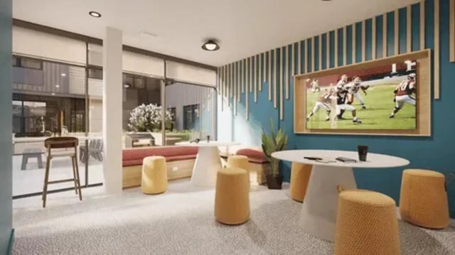 TV bar stools couch tables and ottomans lounge at Global College Station in College Station Student Accommodation
