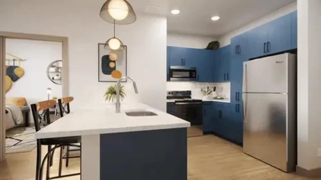 Island kitchen with chairs and open doorway to bedroom kitchen at Global College Station in College Station Student Accommodation
