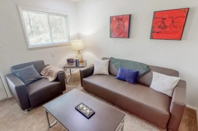 Brown couch, armchair, coffee table, window living room at Apple Lane Apartments in Lawrence Student Accommodation