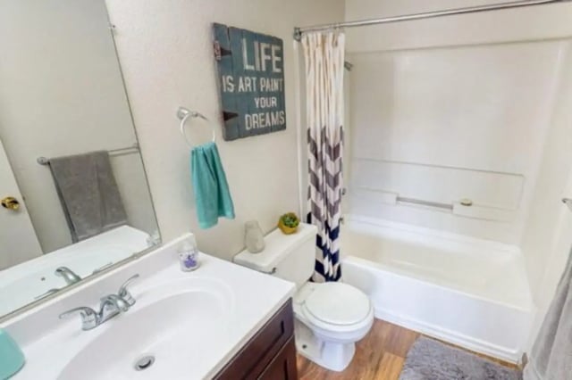 Sink toilet bathtub with curtain wall art Bathroom at Apple Lane Apartments in Lawrence Student Accommodation