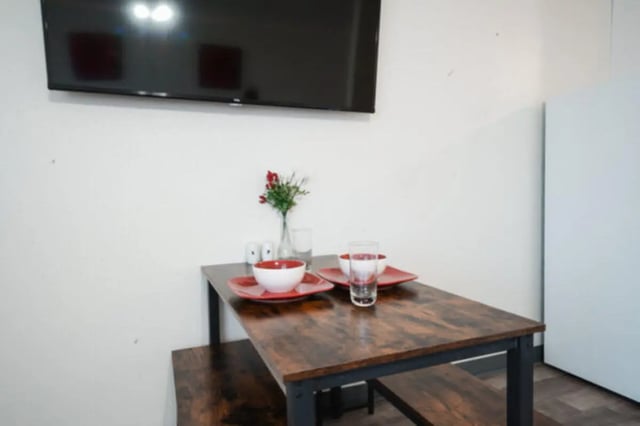 Table with bowls glasses and flowers dining area at Apple Lane Apartments in Lawrence Student Accommodation