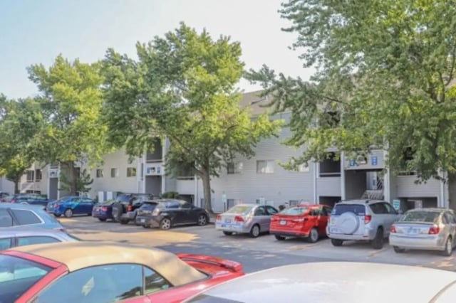 Cars parked at apartment building exterior at Apple Lane Apartments in Lawrence Student Accommodation