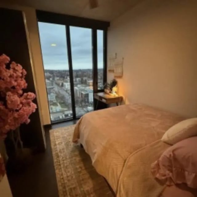 Bed rug desk lamp and city view bedroom at The M Seattle in Seattle Student Accommodation