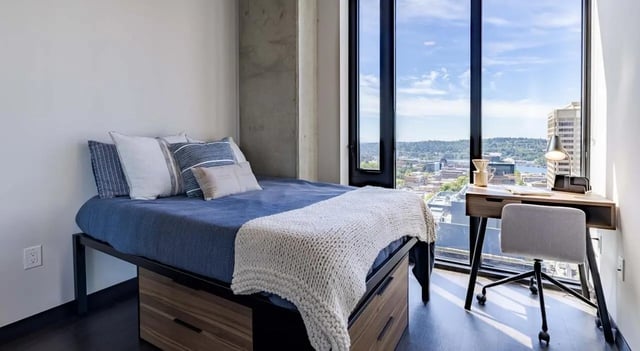 Bed with desk and city view bedroom at The M Seattle in Seattle Student Accommodation