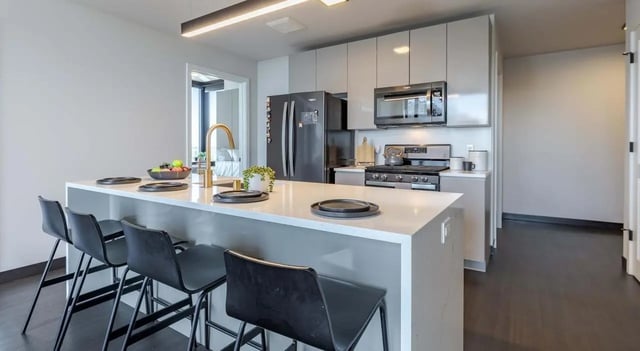 Island bar with stools refrigerator and stove kitchen at The M Seattle in Seattle Student Accommodation